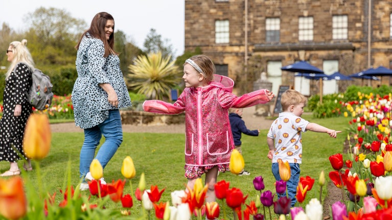Young family enjoying the garden at Ormesby Hall during spring
